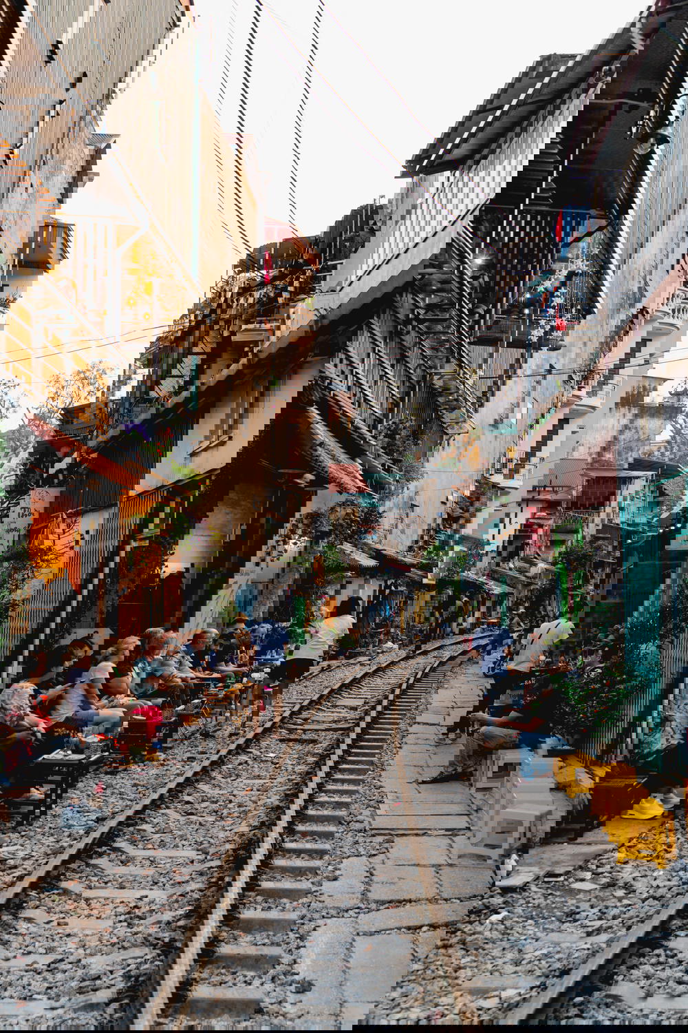A train track runs through the bustling streets of Hanoi in Vietnam.