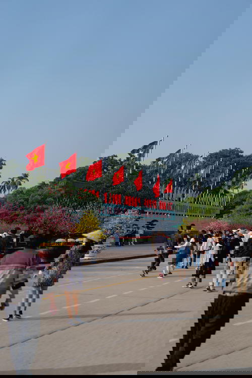 Red Communist flags at Ho Chi Minh Mausoleum travel in Vietnam Hanoi