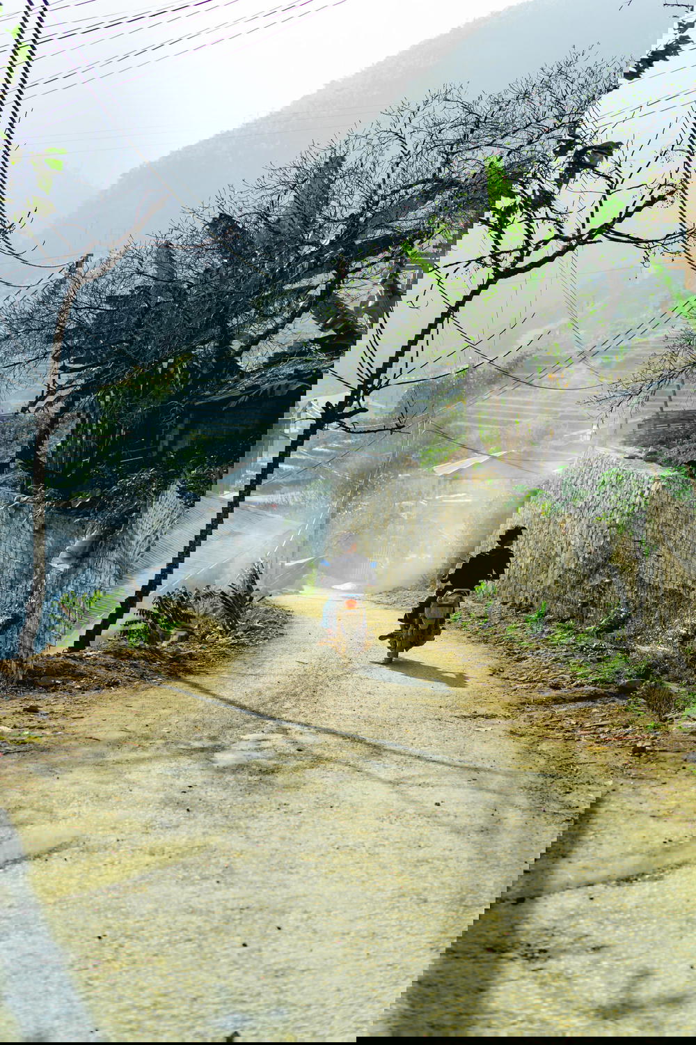 Man driving a motorbike down a dirt road near Sapa, Vietnam