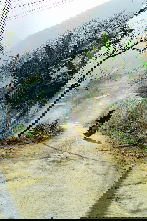 A man riding a motorcycle in Sapa, Vietnam.