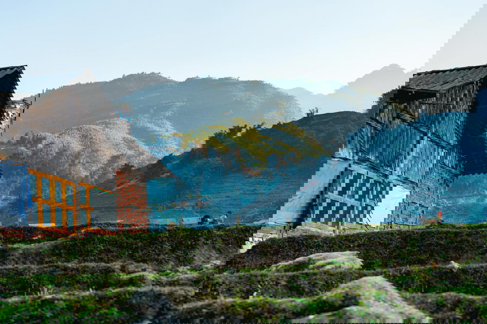Small house surrounded by rice paddies and mountains in a town near Sapa, Vietnam