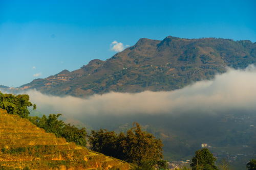 A view of the village of Sapa, Vietnam with a mountain in the background.