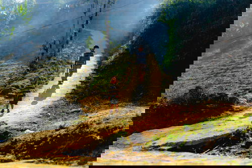 A boy and a girl hiking on a dirt path in Sapa, Vietnam.