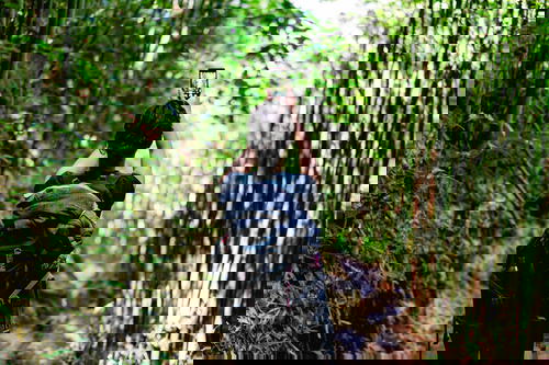 Woman taking photo in bamboo forest in Sapa
