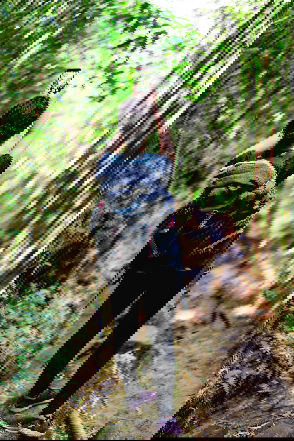Woman taking a photo on a phone during a trek near Sapa